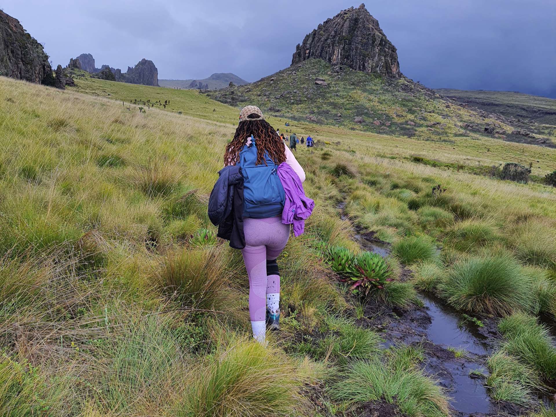 a lady navigating the bogs at mount satima in aberdares. hike curated by hikers arena